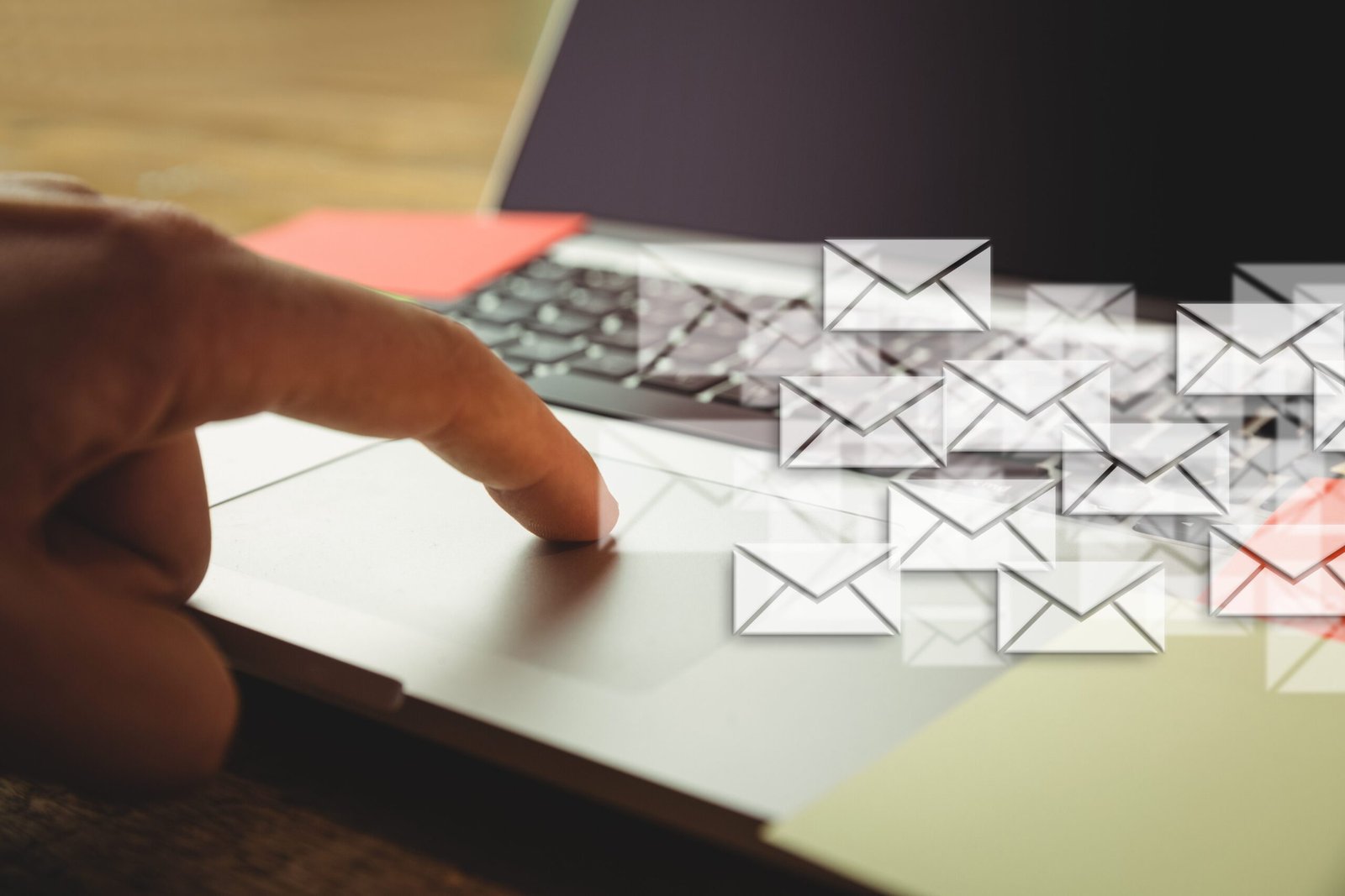 Composite image of hand using laptop put on a desk with letter icons 3 Amazing Email Marketing Platforms