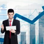 Businessman holding tablet with growing statistics