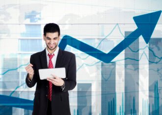 Businessman holding tablet with growing statistics