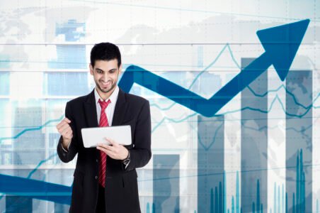 Businessman holding tablet with growing statistics