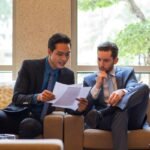 Business professionals reviewing contract documents