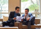 Business professionals reviewing contract documents