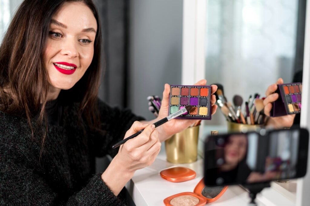 Woman demonstrating an eyeshadow palette for a makeup tutorial.