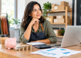ChatGPT Image Sep 10, 2026, 05_04_34 PM Small business owner planning investments with money and financial charts.